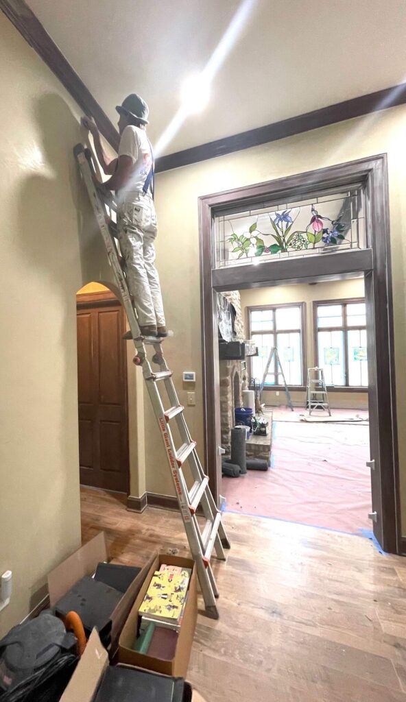 painting contractor on a ladder