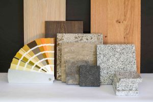 Material collage with natural stone, tiles, wooden parquet floor and color card for renovation