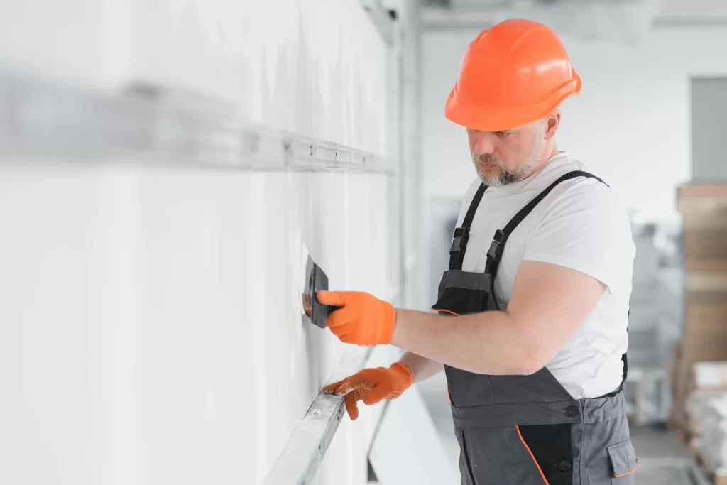 Professional drywall contractor finishing a drywall seam