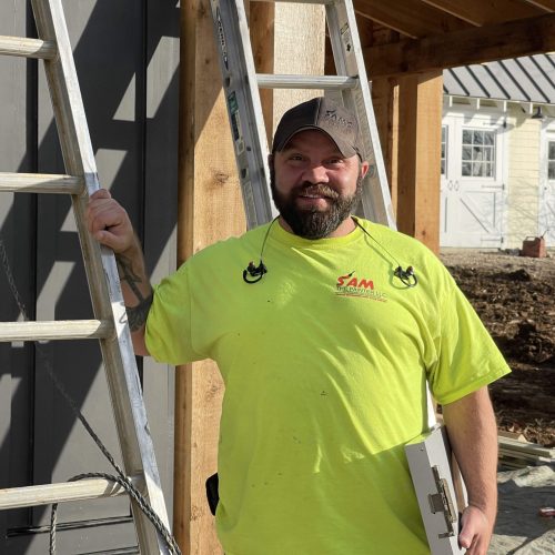 sam painting the exterior of a home